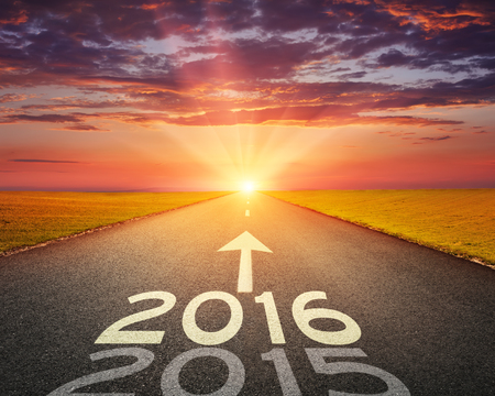 Driving on an empty road towards the setting sun to upcoming 2016 and leaving behind old 2015.