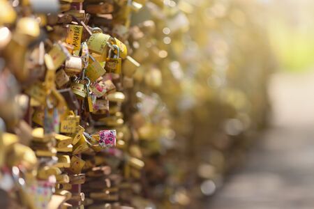 Many romantically love inscribed padlocks on the fence of the bridge Vrnjacka Banja  Serbia. Shallow...