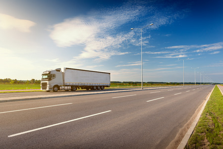 White truck in motion blur on highway at idyllic sunny dayの写真素材