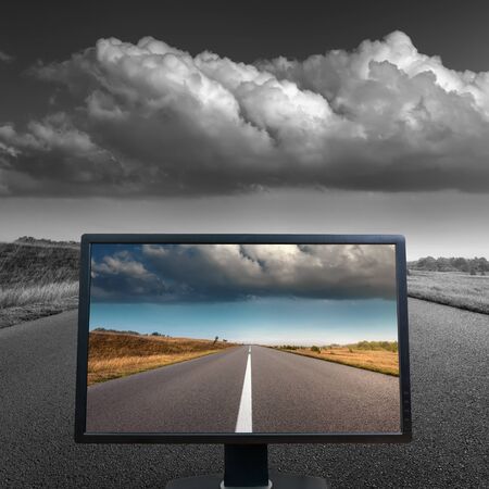 Modern LCD monitor on straight empty asphalt road. Color concept.の写真素材
