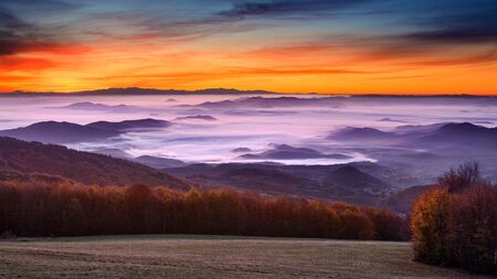 Colorful panorama of the beautiful valley covered with fog at dawn. Sunrise from east side of...