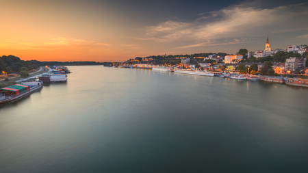 Belgrade coastline as a tourist attraction at beautiful sunset. Left are rafts for entertainment and night life, and on the right port and cruiser boats with the Kalemegdan fortress.の写真素材