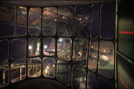 Heavy equipment machinery in night shift work at surface coal mine. Large bucket-wheel excavator in...