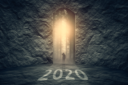 Successful way out and problem solving as silhouette of a lone man to find solution in upcoming 2020 new year. Business and success concept.の写真素材