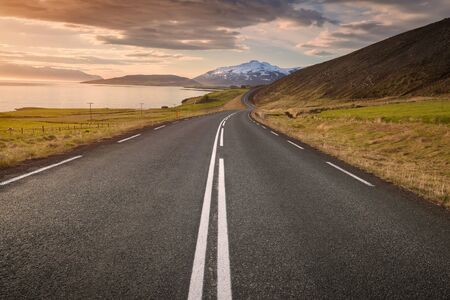 Driving on open road through the beautiful scenery of Akureyri fjord in Iceland as popular travel destination. Freedom concept.の写真素材