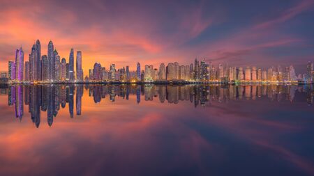 Cityscape of many skyscrapers in Dubai city at popular residential part of town known as Marina and JBR with beautiful sunset.の写真素材