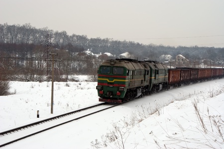 Diesel locomotive with freight train running through winter prairieのeditorial素材