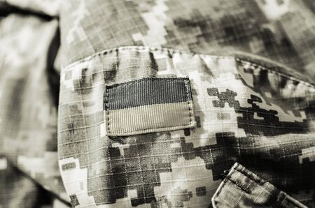 Flag of Ukraine on camo army jacket. Toningの写真素材