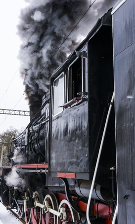 Historic locomotive with black smokeの写真素材
