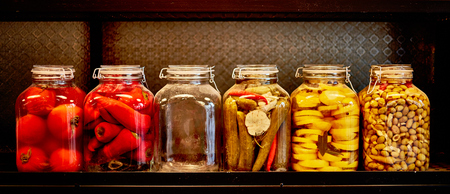 Jars with pickles in a food place, black backgroundの写真素材