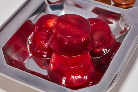 Red jelly strawberry and cherry candy on a metal plate macro.の写真素材