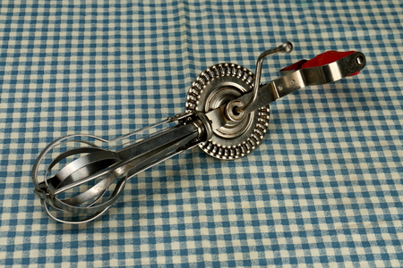Old Hand Mixer on a Retro Checkered Blue Linenの写真素材