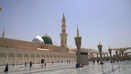 An external image of the Prophet's Mosque in Medina in Saudi Arabia,  It shows the minarets and green dome and sliver dome of the mosque.のeditorial素材