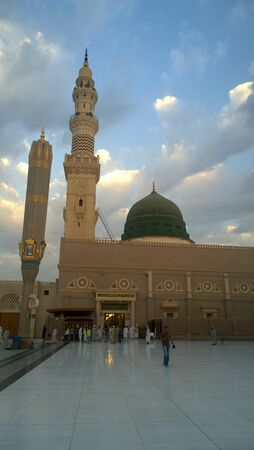 An external image of the Prophet's Mosque in Medina in Saudi Arabia,  It shows the minarets and green dome and sliver dome of the mosque.のeditorial素材
