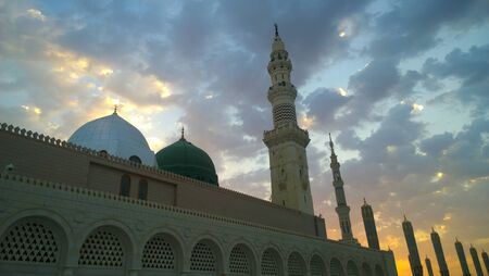 An external image of the Prophet's Mosque in Medina in Saudi Arabia,  It shows the minarets and green dome and sliver dome of the mosque.のeditorial素材
