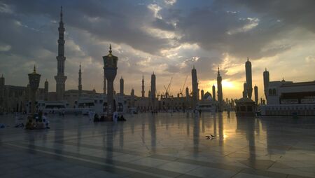 An external image of the Prophet's Mosque in Medina in Saudi Arabia,  It shows the minarets and green dome and sliver dome of the mosque.のeditorial素材