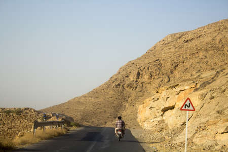 two men ride byic on road in akhlmend ,which is Beautiful tourist area containing waterfalls, mountains and plateaus, It is close to the city of Mashhad in Iran. Frequented by a lot of tourists during their visit to Iran.のeditorial素材