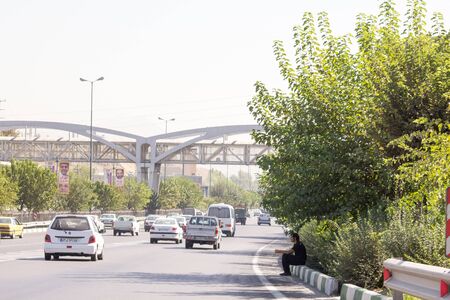 picture of a street in the Iranian city of Teheran, and some passing cars.のeditorial素材