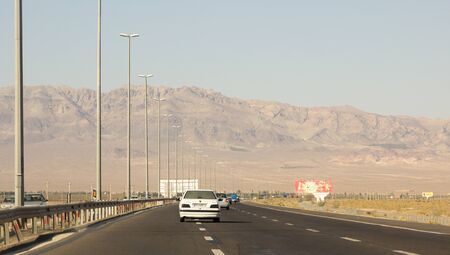 picture of a street in the Iranian city of Teheran, and some passing cars.のeditorial素材