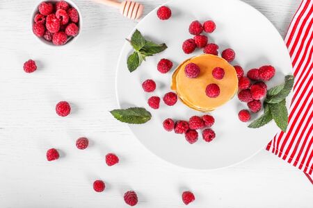 top view of pancakes with raspberries on white wood backgroundの写真素材