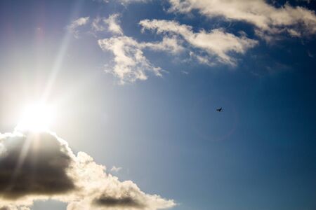 Airplane in the air and sunset in backgroundの写真素材