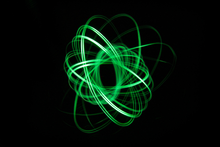 Bright glowing abstract line is photographed on a long exposure