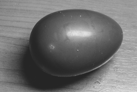 chocolate egg on a wooden table background.の写真素材