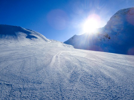 Winter landscape in the mountains. The mountains are covered with snow on a sunny winter day.の写真素材