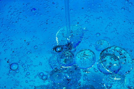 Misted glass, blue and purple rain drops dew drops on colorful abstract cool color background...
