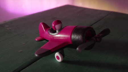 A pink toy airplane for girls with a pilot inside on a wooden table. The cosmic environment and the northern lights. The concept of aviation. 3D illustrationの写真素材