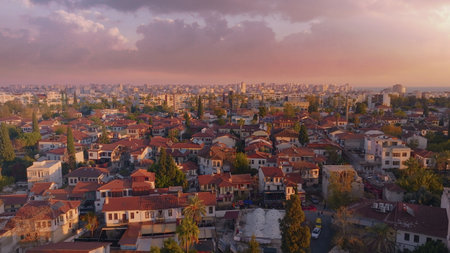 View over the red roofs and medieval wall of the old city. Sunset. Panorama. Aerial drone view. High...