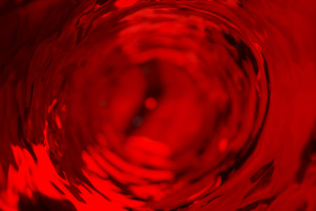 Wine moves in a glass in slow motion. Abstract water background. 3d illustration