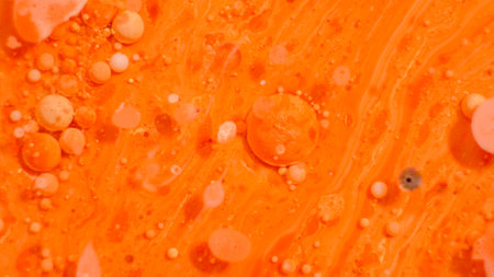 Bright colorful orange bubbles on the surface of the water. Abstract paint bubblesの写真素材