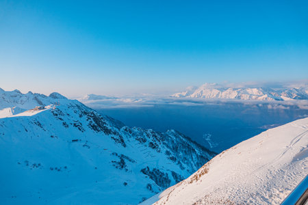 Alpine landscape of snow covered mountains and blue sky