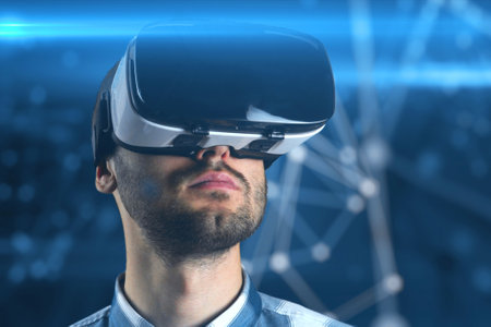 A young man with a beard in glasses of virtual reality on a technological background.
