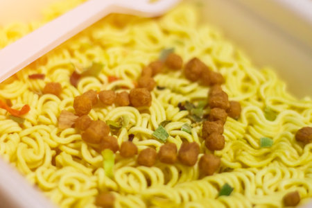 A heart of spices and soy meat on instant noodles cooking. The concept of love for fast food. Prepared with Loveの写真素材