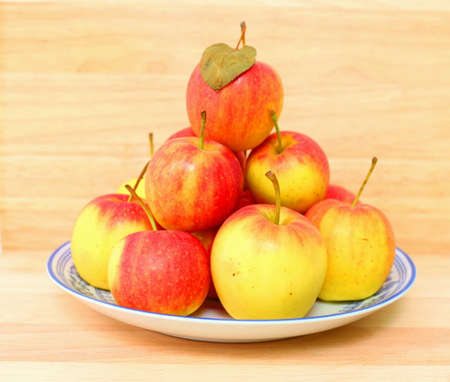 Crab apples on dish with wooden background.の写真素材