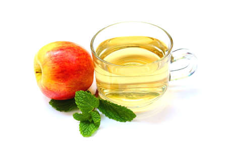 Cup of apple juice with fresh apple and green mint leaves isolated on white background.の写真素材