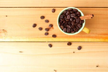 Cup of roasted coffee with cinnamon on wooden background.の写真素材