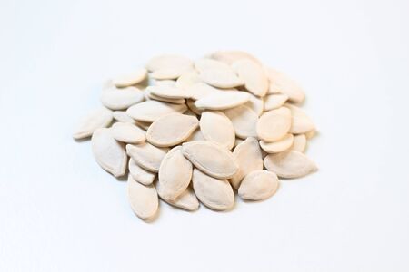 Roasted pumpkin seeds on white background.の写真素材