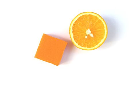 Orange soap bar and a half of fresh and organic navel orange isolated on white background.の写真素材