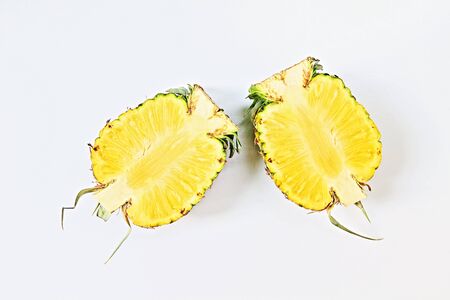 Half of two fresh organic pineapples isolated on white background.の写真素材