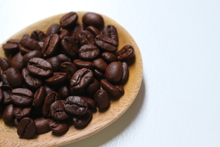 Close up of roasted coffee beans isolated on white.の写真素材