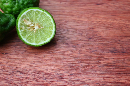 Fresh kaffir limes on wooden background with copy space.の写真素材