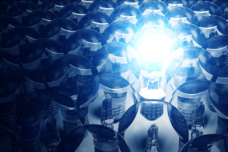 Illuminated Light Bulb standing out from the others Light Bulbs. Individuality Conceptual Backgroundの写真素材
