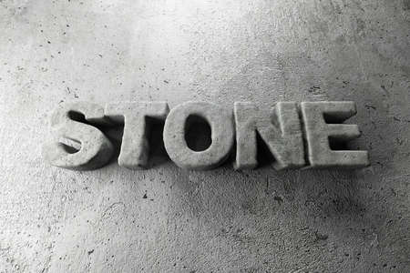 Word STONE on grey textured background, top view. Space for textの写真素材