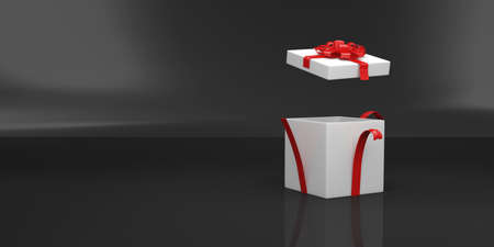 White gift box with red ribbon on black background. 3d renderingの写真素材