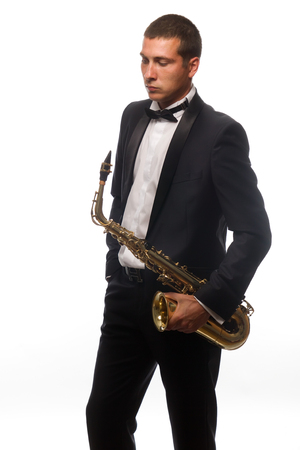 Isolated portrait of young saxophonist in suit with tieの写真素材