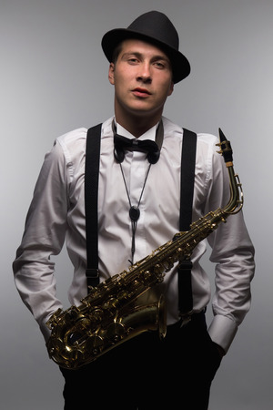 Portrait of saxophone player with hat  DJ with saxの写真素材