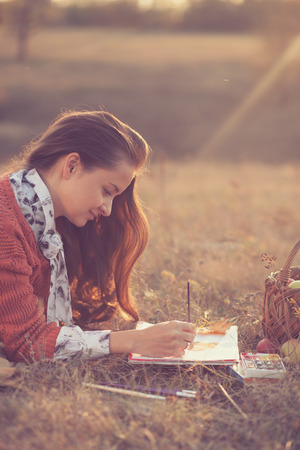 Lying Hipster styled woman drawingの写真素材
